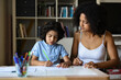 © AUFORT Jérome - metis mother tutoring her son at home