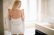 © JustLife - Beautiful woman wearing a bathrobe. Young happy woman enjoing in hotelroom.