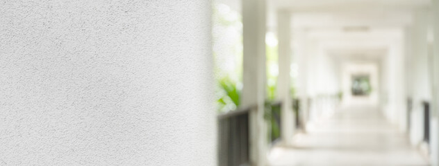 white cement texture with blur perspective of corridor with sunlight architecture banner background