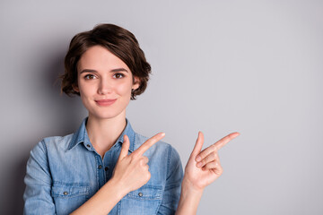 Closeup photo of attractive beautiful lady direct fingers side empty space showing nice offer sales manager business woman wear casual denim shirt isolated grey color background