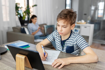 Sticker - children, education and school concept - student boy with tablet pc computer and test learning online at home