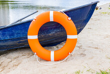 Life Buoy Hanging On Board The Boat. The Boat Stands On The Banks Of The River. Water Safety Concept.