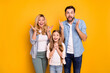 © deagreez - Photo wife beautiful mother lady husband dad guy little school girl daughter listen amazing good news raise arms shocked wear casual shirts clothes isolated yellow color background