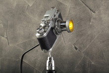 A Vintage Lamp Made By Me From An Old Rangefinger Film Camera Zorki Relased On 1955 On A Gray Cement Background.