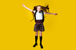 © khmelev - Full length photo of little funny crazy little lady schoolgirl pupil jump in uniform with backpack on vibrant yellow background, back to school, learning education concept