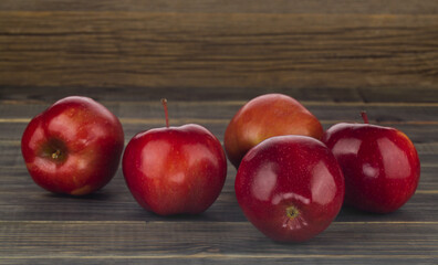 Red apples on a wooden background.