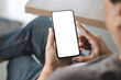 © onephoto - Top view Mockup image hand using a smartphone man Holding Cell Phone With Blank Screen