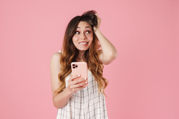 Canvas Print - Image of joyful cute woman using cellphone and looking aside