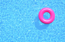 Clear Water In Swimming Pool With Pink Swimming Ring. Top View, 3d Illustration