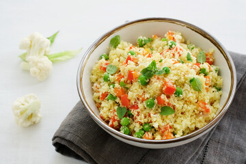 Wall Mural - Cauliflower rice in a bowl on a white background. Paleo Food Diet Concept