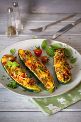 Canvas Print - Zucchini stuffed with meat, vegetables and cheese. Zucchini boats. Loaded zucchini. Vertical image