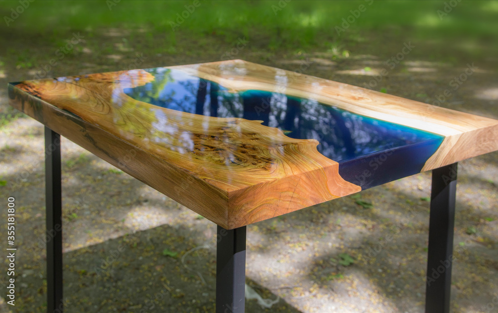 Beautiful wooden table made of elm slab with epoxy resin filling - obrazy, fototapety, plakaty 