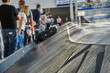 © bakharev - moving conveyor belt with suitcases at baggage claim at airport.