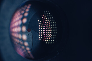 Poster - Close up Beautiful Camera Lens on a dark with pink reflection light background. Macro view.