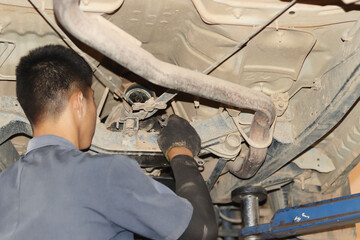 auto mechanic changing car engine