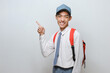 © Heru - Indonesian Senior Student wearing uniform pointing at copy space or blank space