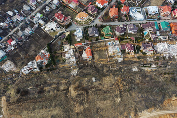 Wall Mural - Landslide caused by rains of hurricane destroyed expensive cottages and houses. Destroyed house, cottage, large cracks, chips, slabs. Broken asphalt shifted landslide after earthquake. View from drone