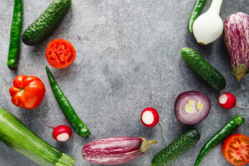 Wall Mural - Colorful summer pattern with different fresh vegetables on a grey background. Flat lay, top view.