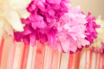 Wall Mural - decorated background for girl's birthday from pink pompoms and ribbons