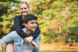 © calcassa - Cheerful man giving piggyback ride to woman