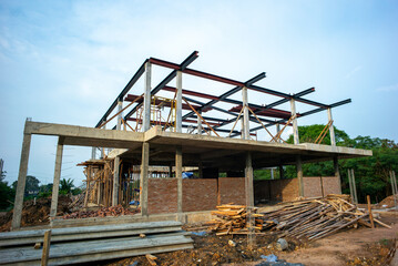 Perspective of house structure under construction at site with blue sky background