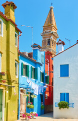 Wall Mural - Street and leaning old bell tower in Burano in Venice,