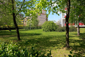 Wall Mural - Lots of lush vegetation next to multifamily houses