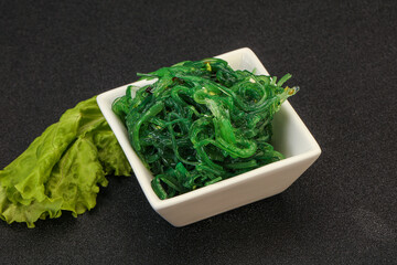 Green Chuka Seaweed Salad Isolated on White Background Top View. Wakame Sea Kelp Salat