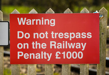 Red Sign Warning People Not To Trespass On The Railway Track. No People.