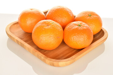 Bright yellow juicy, fresh, organic tangerines, close-up, on a white background.