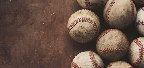 Sticker - Group of old used baseball balls for sport, copy space on grunge brown background for vintage style.