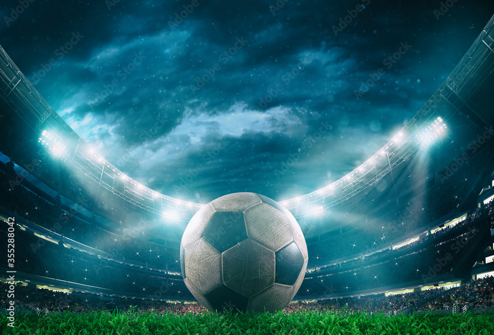 Close up of a soccer ball in the center of the stadium illuminated by the headlights - obrazy, fototapety, plakaty 