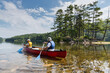 © romylee - father and son canoeing in a lake