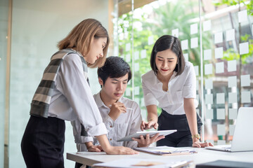 Young asian modern people in smart casual wear having meeting planning work together as a team and present ideas at work.