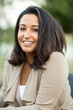 © digitalskillet1 - Young confident happy Hispanic woman smiling outside.