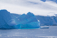 Iceberg In Antarctica With Blue Reflection In The Water