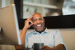 © digitalskillet1 - Mature African American man working from his home office.