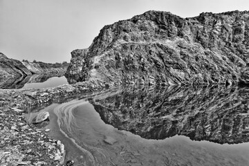 Wall Mural - Black and white nature view of a rock mountain from an abondon mine with its reflection from the man made lake