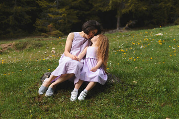 Canvas Print - mother and daughter on stone