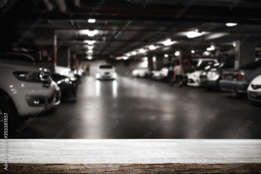 Empty desk platform over car park background. For product display ...