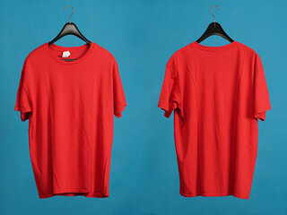 Exclusive hanger with empty red t-shirt hanging isolated on a blue background. Blank red male tshirt template, from two sides,  for your mockup design to be printed.