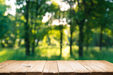 Empty Wooden Deck Table With Park Bokeh Background.