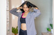 © supAVADEE BUTRADEE - Beautiful women in sportswear wear shirts to prepare to work at home.
