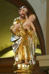 Saint Joseph holds the baby Jesus statue in the parish church of the Holy Cross in Sveti Kriz Zacretje, Croatia