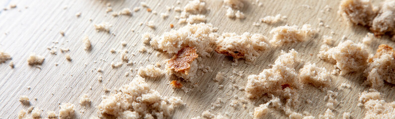 Sticker - Bread crumbs on a wooden table.