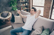 © deagreez - Portrait of his he nice attractive glad confident cheerful cheery muscular virile guy resting switching cool AC mode at modern industrial loft brick interior style living-room