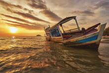 Beached Fishing Boat During Sunset At Otres Beach In Sihanoukville
