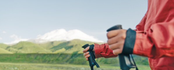 Sticker - Female hands with trekking poles in front of mountain Elbrus.