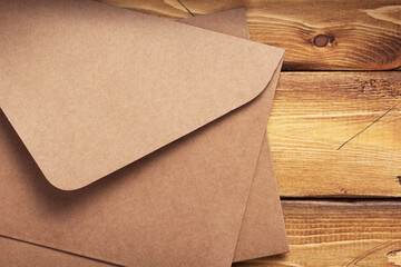 Wall Mural - old cardboard postal envelope at wooden background