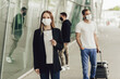 © Olha - Figures of young people in protective masks near the airport. Safe travel during a pandemic. Airplane travel, quarantine and pandemic concept
